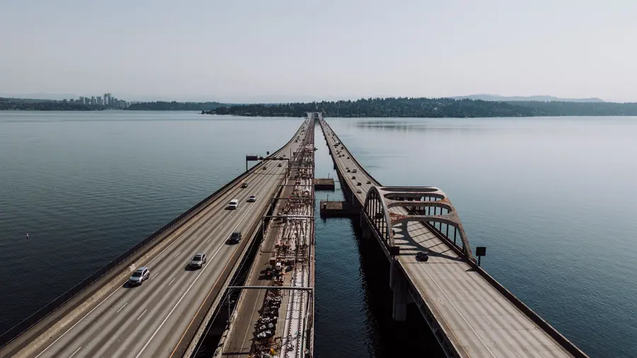 The floating bridge across Lake Washington seen from above on a grey morning, Bellevue on the far shore.